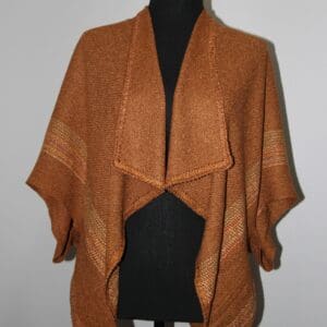 Brown knitted shawl on a mannequin.
